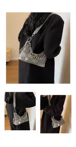 Detail view of silver metallic distressed texture with crossbody chain and shoulder strap