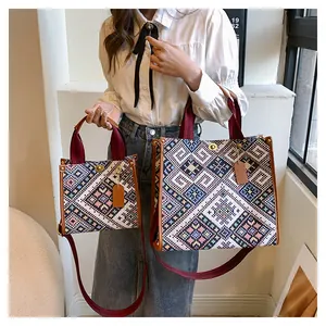 Detail view of ethnic canvas tote bags with leather trim and wide textile shoulder strap
