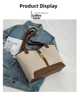 Detail of canvas tote bag with coffee brown leather trim and golden metal lock buckle
