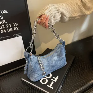 Blue denim texture tote bag with thick silver chain handle and minimalist urban style