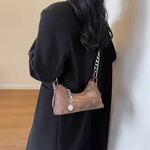 Retro brown leather underarm bag with decorative stitching and silver chain strap