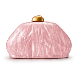 Detailed view of pink marble pattern acrylic shell clutch with gold metal clasp closure