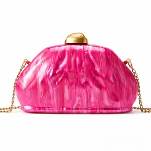 Close-up of pink marble acrylic evening clutch with luxury gold geometric metal clasp