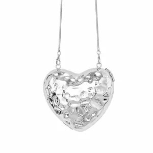 Silver heart-shaped evening clutch bag with hammered metal texture and slim chain strap