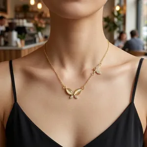 Titanium butterfly necklace with 18K gold plating, cat's eye stone, and zircon pendants