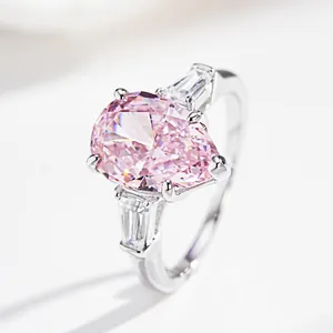 Elegant S925 silver ring featuring pear-cut pink gemstone with trapezoid side stones
