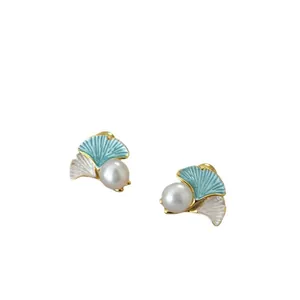 Ginkgo leaf pearl stud earrings featuring blue and white enamel with gold-tone finish