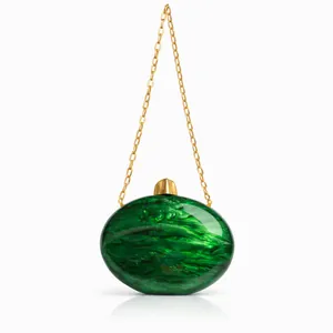Detail of green marble acrylic evening clutch featuring gold chain and metal clasp