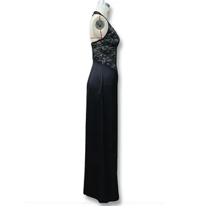 Side view of elegant black halter dress featuring floral lace panels and a flowing skirt