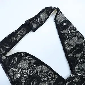 Detail of elegant black floral lace halter neck with double button closure and hollow texture