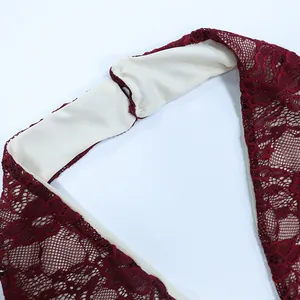 Detail of wine red lace stitching with cream lining on the halter neck dress
