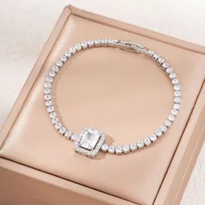 Elegant rectangle emerald cut zircon tennis bracelet with silver finish on champagne satin