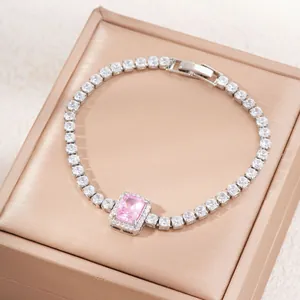 Luxurious silver tennis bracelet with a rectangular pink zircon and halo setting