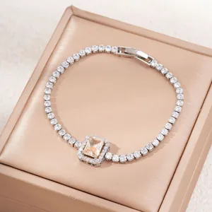 Detailed macro view of champagne rectangular zircon and silver paved diamond bracelet