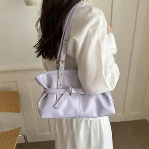 Detail view of adjustable strap with metal buckle on the lavender pleat shoulder bag