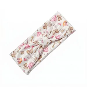 Elastic satin headband featuring Disney print with pink clouds and golden bows