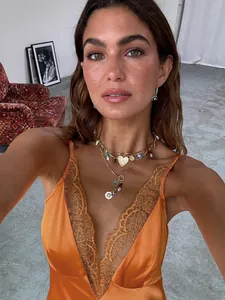 Model wearing a sexy orange summer slip dress with elegant lace trim and V-neckline