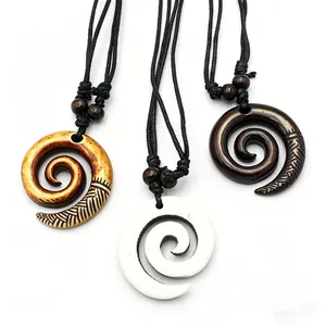 Three tribal Maori spiral pendants in resin and faux bone with black cords on white background
