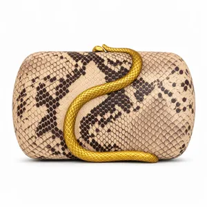 Macro shot of faux snakeskin texture and ornate golden serpent clasp on the clutch