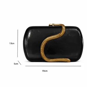 Detailed view of black patent leather evening bag with golden snake buckle and dimensions