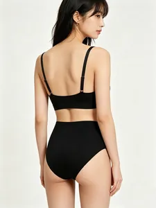 Back view of black seamless stretch bralette and high-waist briefs set on a female model