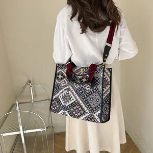 Ethnic style large canvas tote bag with geometric embroidery and red shoulder strap