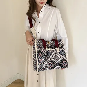 Ethnic woven tote bag with geometric patterns and red handles for daily casual use