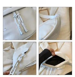 Detail view of white PU leather crossbody bag with embossed texture and chain strap