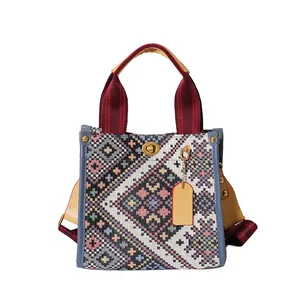 Ethnic style canvas tote bag with colorful geometric patterns and blue leather trim