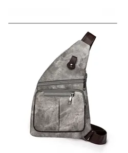 Vue de face du sac bandoulière en toile grise montrant le tissu et les deux fermetures