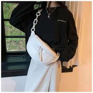 Detail of white PU half-moon crossbody bag with embossed letters and chunky chain strap