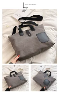 Detail of grey canvas tote bag showing black leather pocket and spacious design