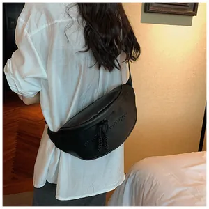 Detail of black crescent PU leather crossbody bag with m.de proper embossed texture