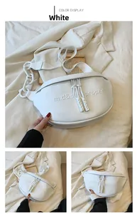 Detail of white PU crescent bag with embossed letters and chunky white chain link
