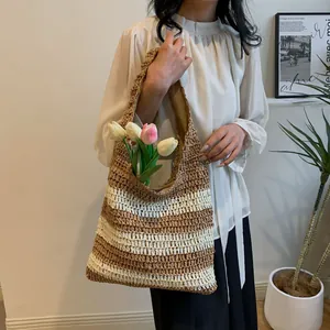 Detail of hand-woven straw tote bag with brown and white stripes for summer vacation