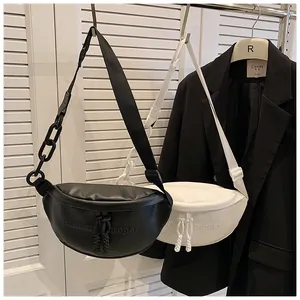 Detail of minimalist PU crescent bag with matte finish and stylish chain decoration