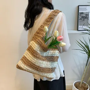 Detail of striped woven straw tote bag with brown and cream texture for beach vacation