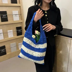 Close-up of blue and beige striped crochet knit tote bag with large storage capacity