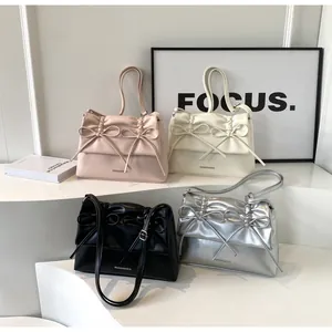 Collection of four PU leather shoulder bags in pink, beige, black, and silver with bows