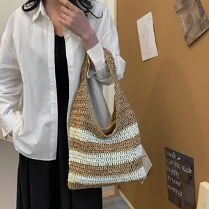 Close-up of beige and white striped straw tote bag in a stylish lifestyle setting
