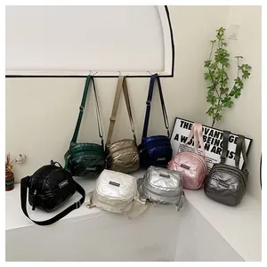 Detail view of colorful quilted nylon crossbody bags with fashion label and adjustable straps