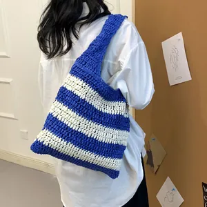 Detail showing hand-woven texture and blue white striped pattern on oversized tote bag