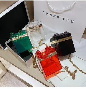 Detail of colorful transparent acrylic chain handbags with gold metal frames and locks