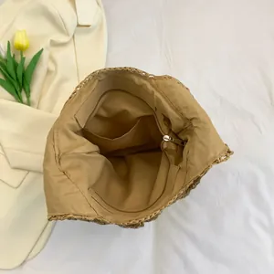 Hollow out straw tote bag interior with zipper pockets for beach vacation use