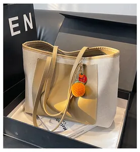 Close-up of canvas tote bag in gift box with persimmon charm and holiday card