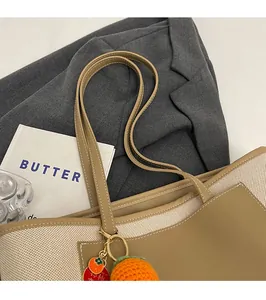 Close-up of the durable leather straps and canvas texture on a stylish tote bag
