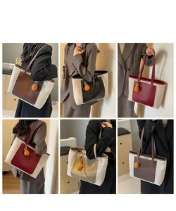 Detail view of large canvas and leather tote bags with knit orange charms in multiple colors