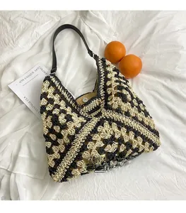 Detailed view of handmade woven straw tote with hollow lattice pattern and magnetic snap