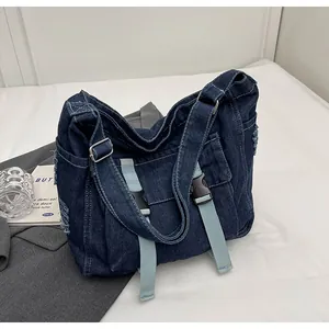 Detailed view of heavy denim tote bag with buckle closure and stylish frayed edge details