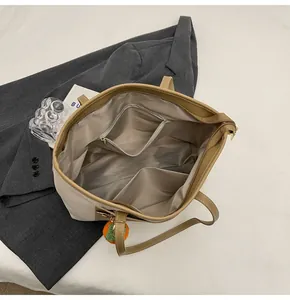 Internal layout of large tote bag showing zipper pocket and dual slot compartments